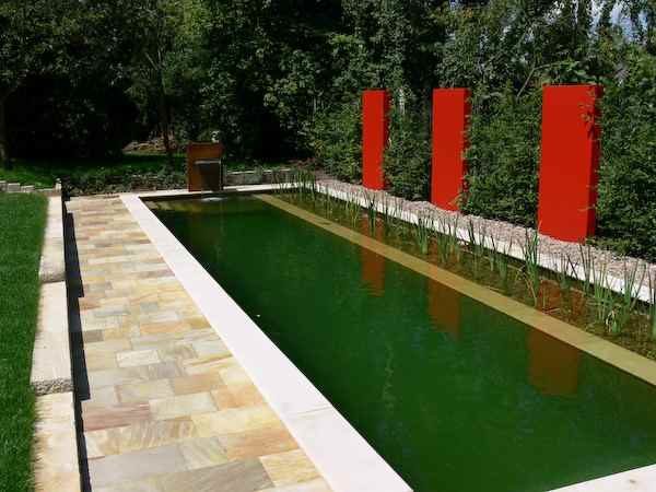 Wasserfall freihstehend mit rostiger Rückwand stehend im Gartenteich als